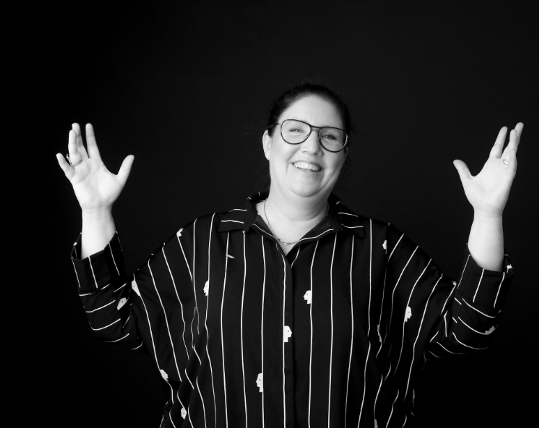 Susanne Krogh Hansen, laughing with her hands raised